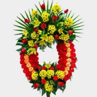 Corona de flores para difuntos con los colores de la bandera de Espaa