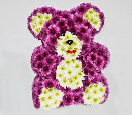 oso de peluche con flores naturales